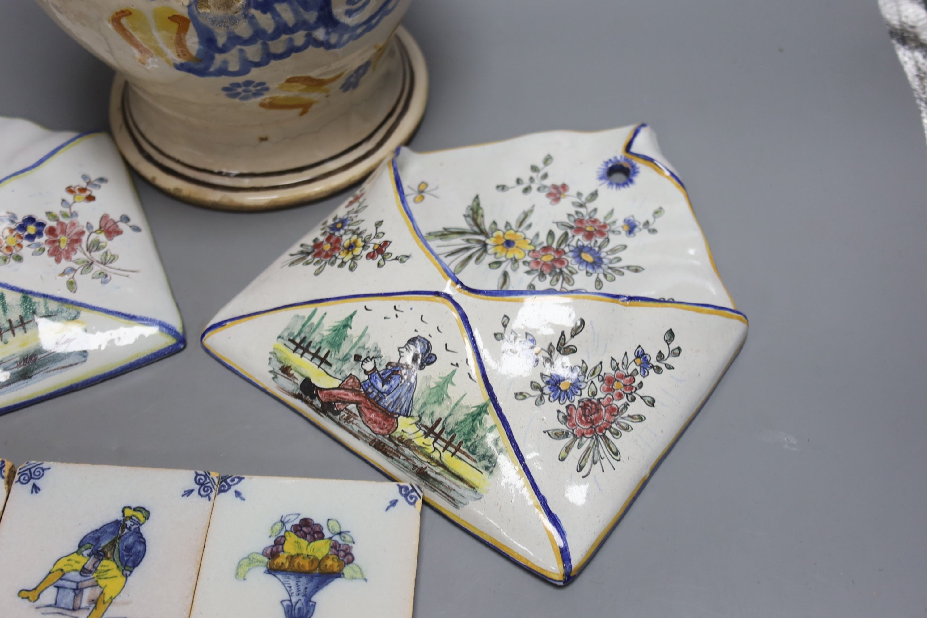 A pair of Delft wall brackets, a set of six delft small tiles and a large maiolica pitcher, height 30cm